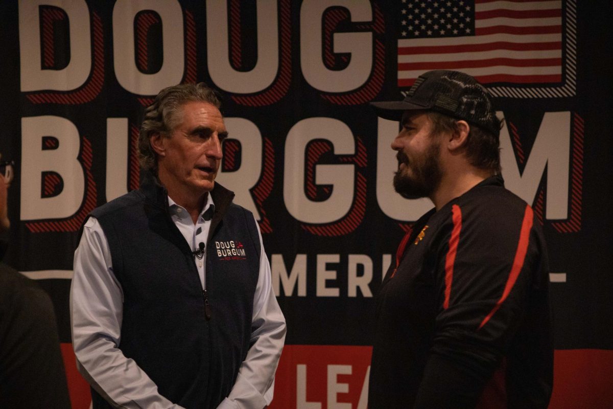 Doug Burgum talking to Logan Hull on October 19, 2023 at a Campaign stop at Jethros BBQ in Ames, Iowa.