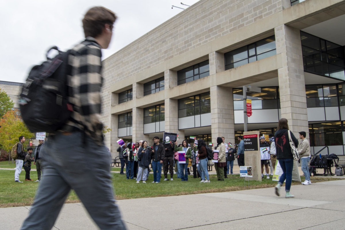 Attendees of the Stand with Gaza gathering begin to show up on Thursday, Oct. 19, 2023, outside of Parks Library in Ames, Iowa.
