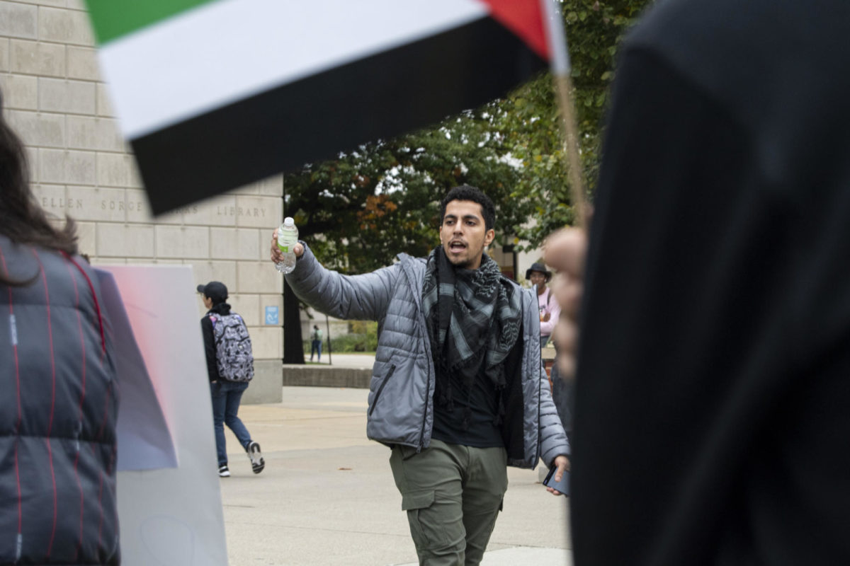 Mohammad, one of the chant leaders, begins a call and response during the Stand with Gaza gathering on Thursday, Oct. 19, 2023, outside of Parks Library in Ames, Iowa.