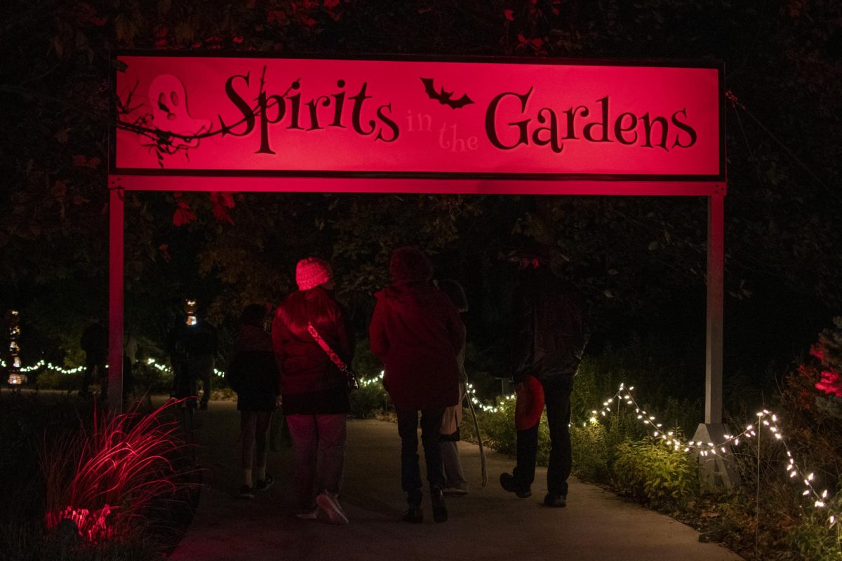 Attendees of the Spirits in the Gardens fall celebration walk through the entrance on Saturday, Oct. 21, 2023, at Reiman Gardens in Ames, Iowa.
