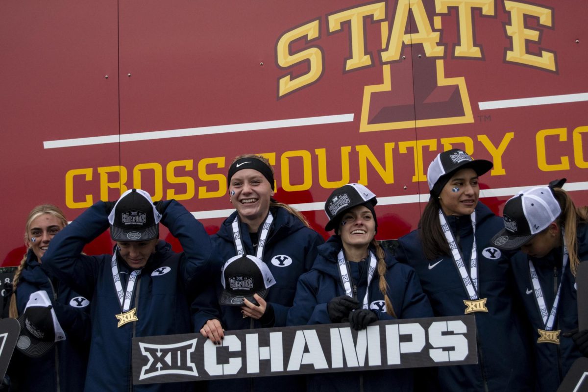 Members of the Brigham Young Women’s Cross Country team start to celebrate their win during the Big 12 Women’s Cross Country Championship award ceremony on Saturday, Oct. 28, 2023, at the Iowa State University Cross Country Course in Ames, Iowa.
