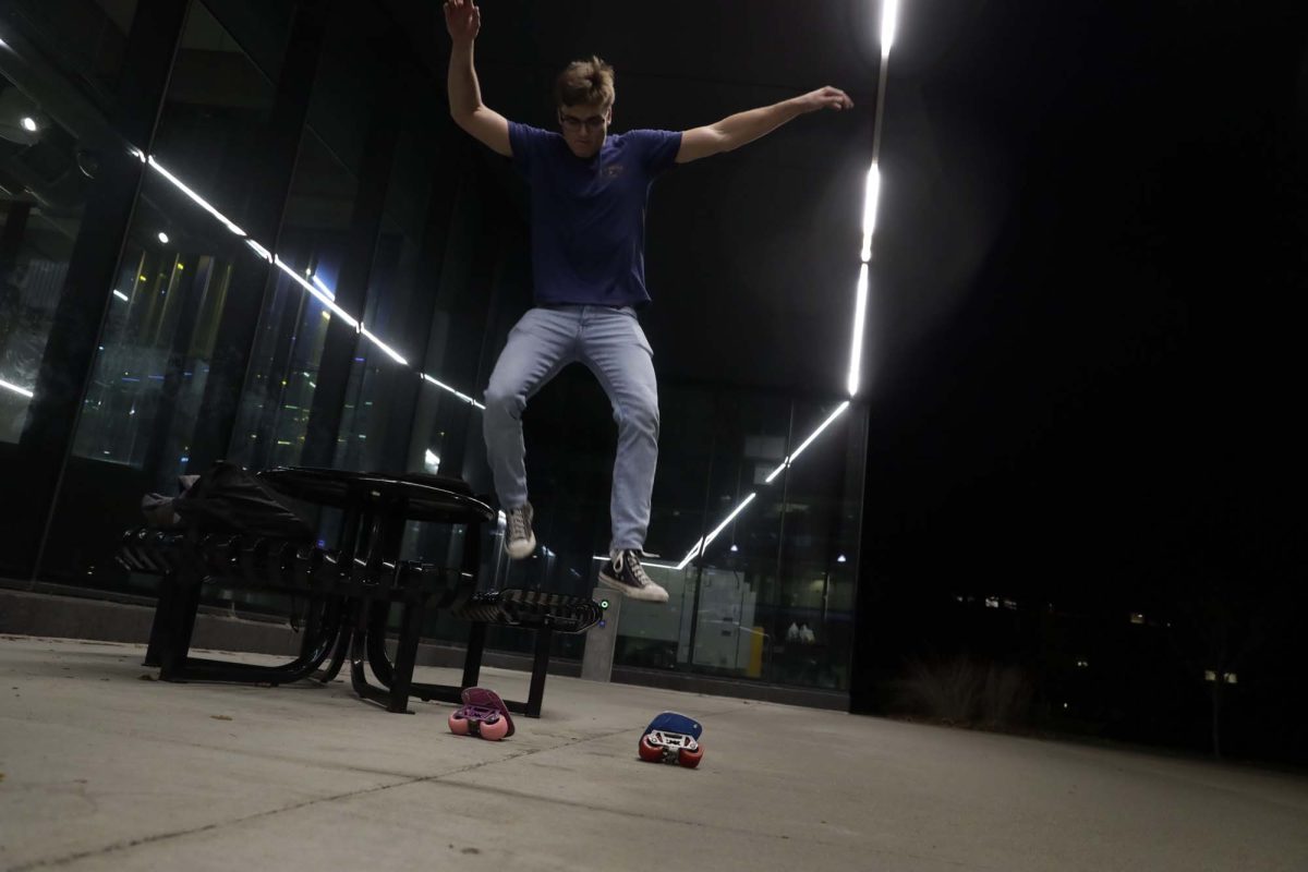 Michael Deely, a sophomore studying mechanical engineering, jumps off a table onto a pair of freeskates at the Open Spaces event at the Student Innovation Center Oct. 26.