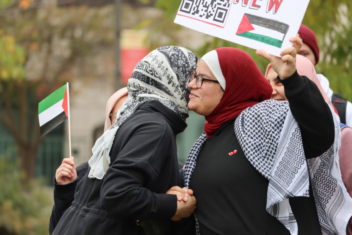 Two attendees greet each other at the Stand with Gaza gathering, outside of Parks Library, on Oct. 19, 2023.