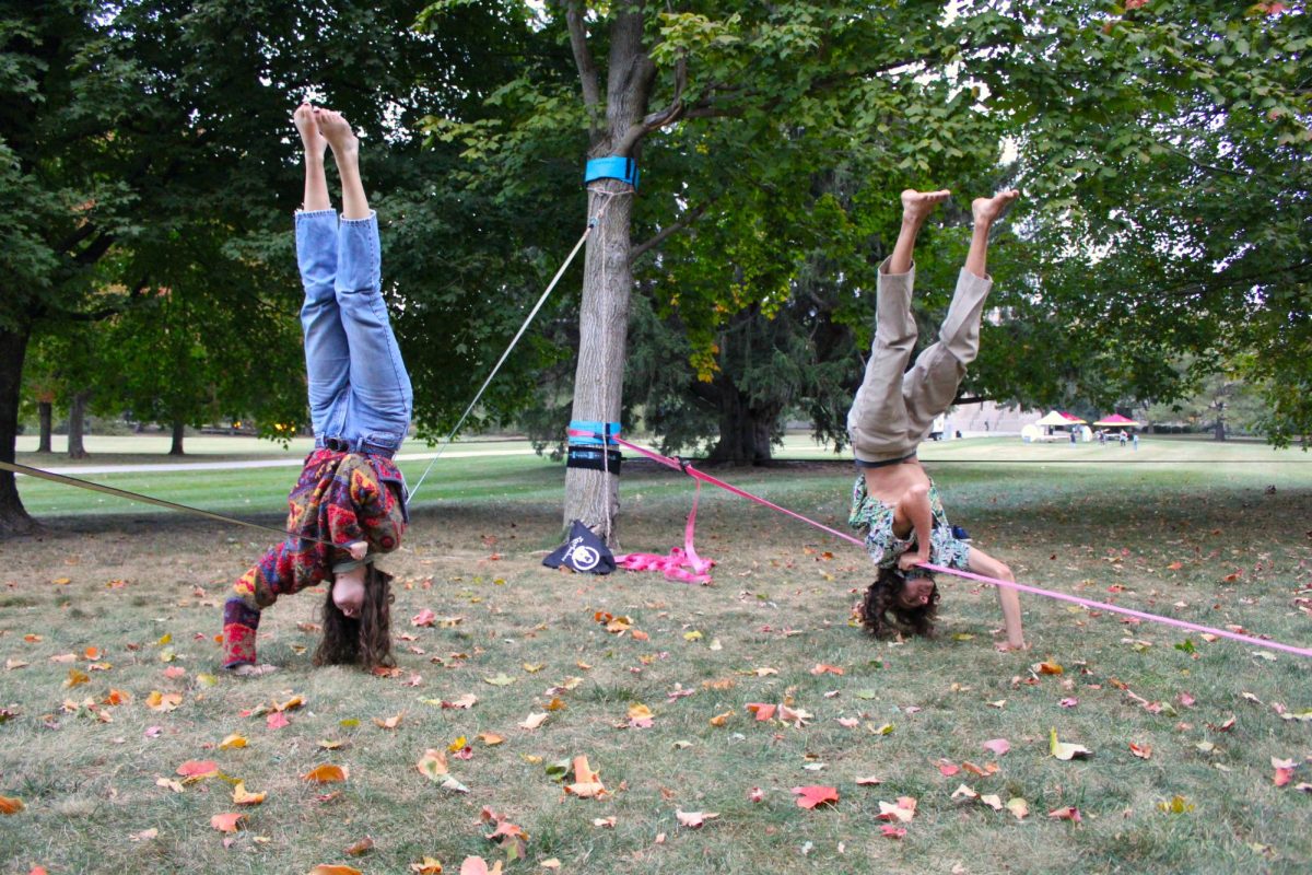 Lindsey Broderick, a senior in geology and Wesley Anderson, a junior in forestry doing shoulder stands on central campus Wednesday, Oct. 4. 
