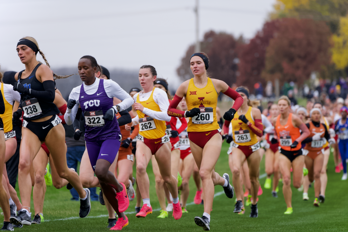 Runners competing in the Big 12 Women’s Cross Country Championship in Ames, Iowa pile up going around a turn on Oct. 28, 2023