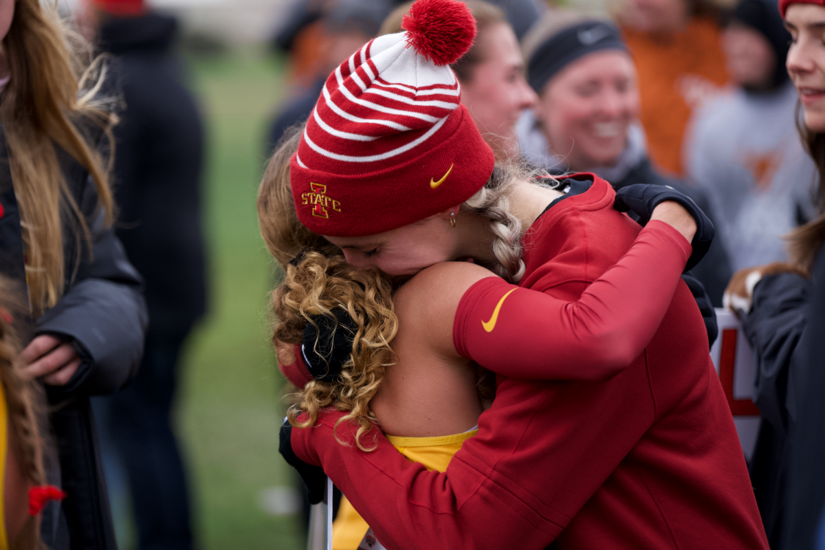 Janette Schraft hugging a friend after a cold run at the Big 12 Championship on Oct. 28, 2023 in Ames, Iowa.