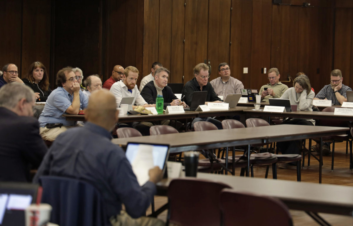 Members of the Faculty Senate listen to the meeting agenda at the Memorial Union on Oct. 10, 2023.