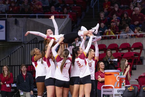 Cyclones carry teammate in celebration during the Iowa State vs. University of Central Florida Volleyball Game, Hilton Coliseum, Nov. 22, 2023.