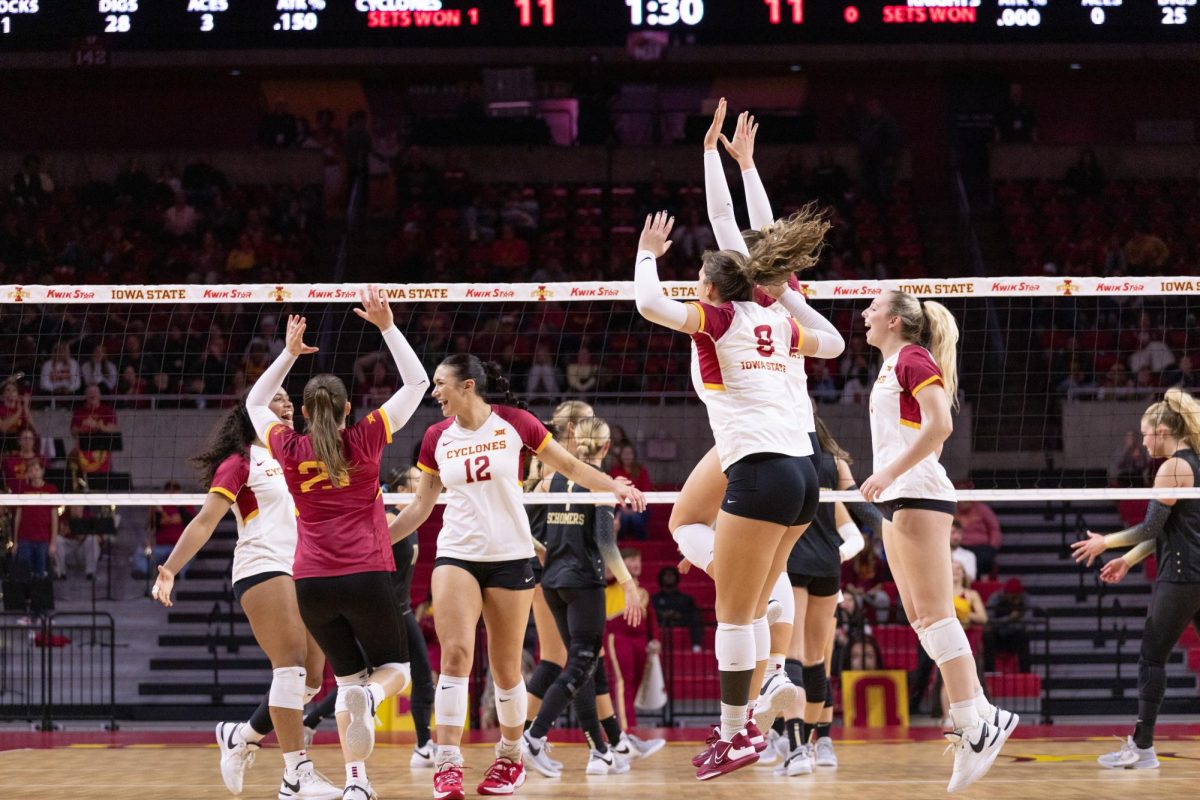 Cyclones jump in excitement after scoring a point during the Iowa State vs. University of Central Florida Volleyball Game, Hilton Coliseum, Nov. 22, 2023.