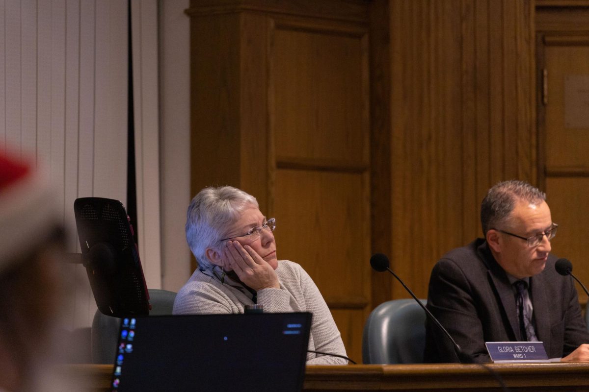 Ames City Council Member Gloria Betcher looks up at map during presentation during City Council Meeting, Nov. 28, 2023.
