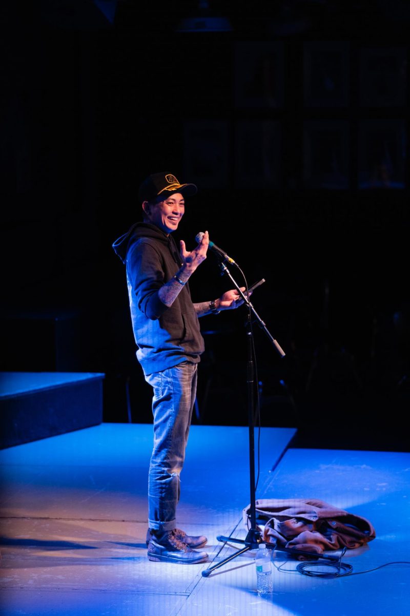 Asia Samson laughs while making a joke about Covid-19 resulting in the unfollow function of social media being used more often. Spoken Word Night at the Maintenance Shop Memorial Union, Nov. 14, 2023.