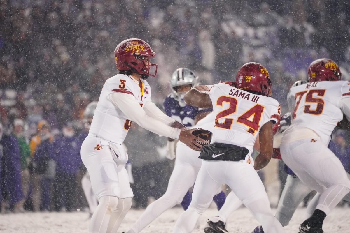 Rocco Becht hands off the ball to Abu Sama III at the Iowa State vs. Kansas State football game at Bill Snyder Family Stadium on Nov. 25, 2023 in Manhattan, KS.