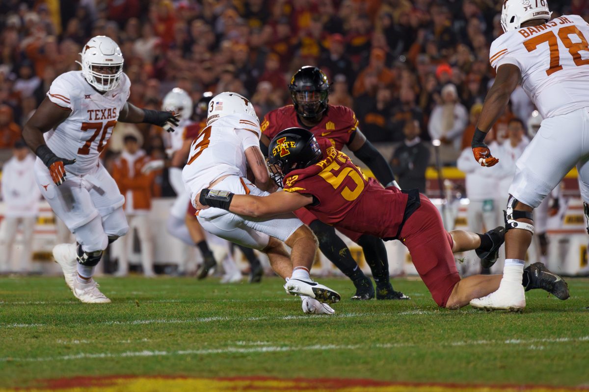 Joey Petersen of Iowa State tackling Texas QB Quinn Ewers during the Iowa State vs. Texas football game on Nov. 18, 2023 in Jack Trice Stadium.