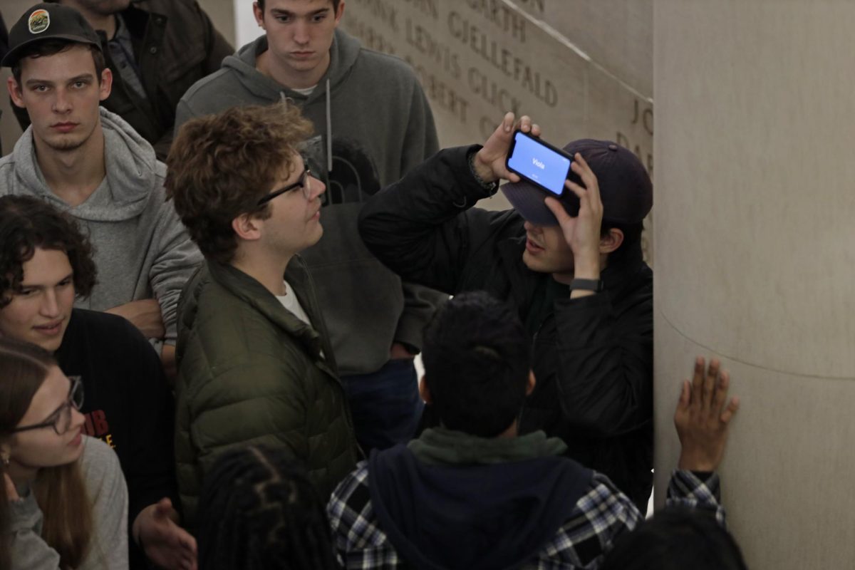 A group of students play Heads Up as they wait to be let into the Durham Great Hall in the Memorial Union after the building was evacuated. The evacuation was due to the fire alarms going off minutes before Giancarlo Esposito was supposed to give an interview at AfterDark on Friday Nov. 10, 2023.