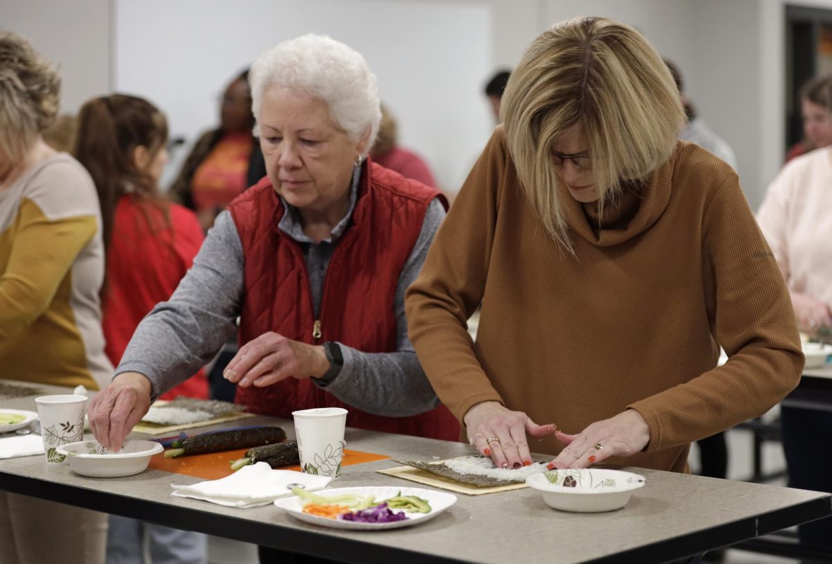 Liz Kurt, left, and Stephanie Salasek, right, each prepare their second sushi roll during the Sushi Workshop held by the Culinary Science Club in the Culinary Discovery Lab on Friday, Nov. 10, 2023.