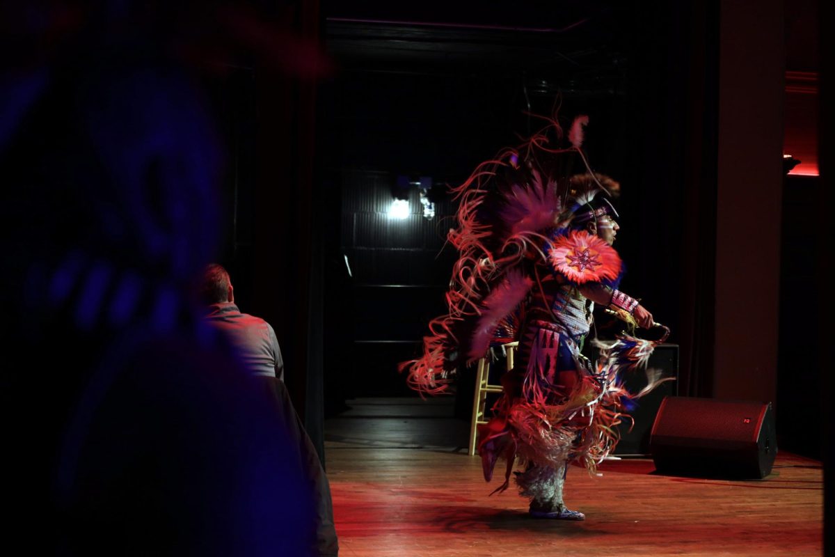 Romeo Buffalo watches his uncle, Larry Yazzie, a Native American storyteller and fancy dancer, perform in the Great Hall of the Memorial Union on Thursday, Nov. 30, 2023. Buffalo and Yazzie a members of the Meskwaki Nation. Located in Tama, it is the only federally recognized tribe in Iowa.