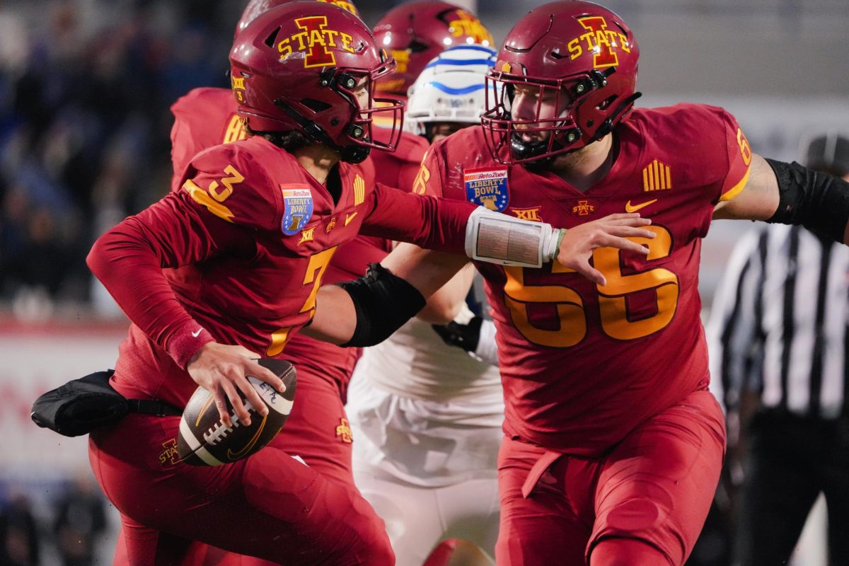 Quarterback Rocco Becht pushes off offensive lineman Tyler Miller to create space for a pass during the Iowa State vs. Memphis 2023 AutoZone Liberty Bowl, Simmons Bank Liberty Stadium, Dec. 29. 2023.