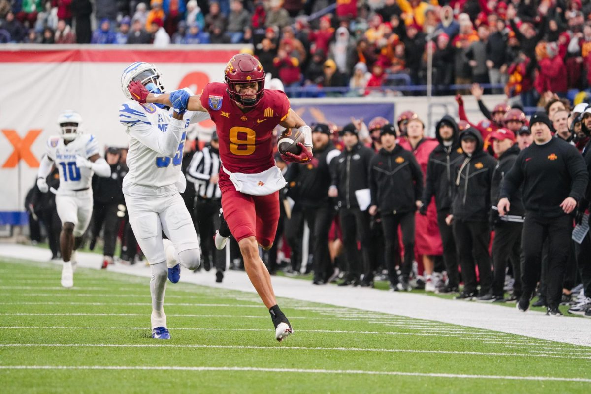 Jayden Higgins pushes a Memphis defender off while rushing to the end zone during the 2023 AutoZone Liberty Bowl, Simmons Bank Liberty Stadium, Dec. 29. 2023.