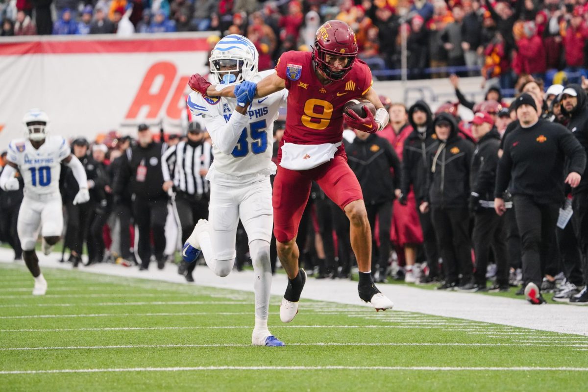 Jayden Higgins pushes a Memphis defender off while rushing to the end zone during the 2023 AutoZone Liberty Bowl, Simmons Bank Liberty Stadium, Dec. 29. 2023.