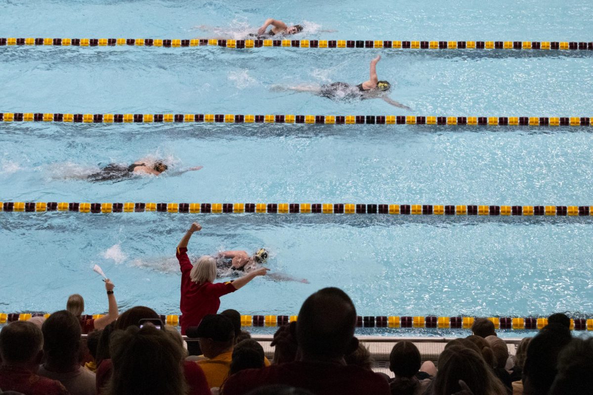 Iowa State’s swim and dive assistant head coach Kelly Nordell cheers on the Cyclone swimmers during the meet against Iowa on Friday, Dec. 8, 2023, at Beyer Hall in Ames, Iowa.