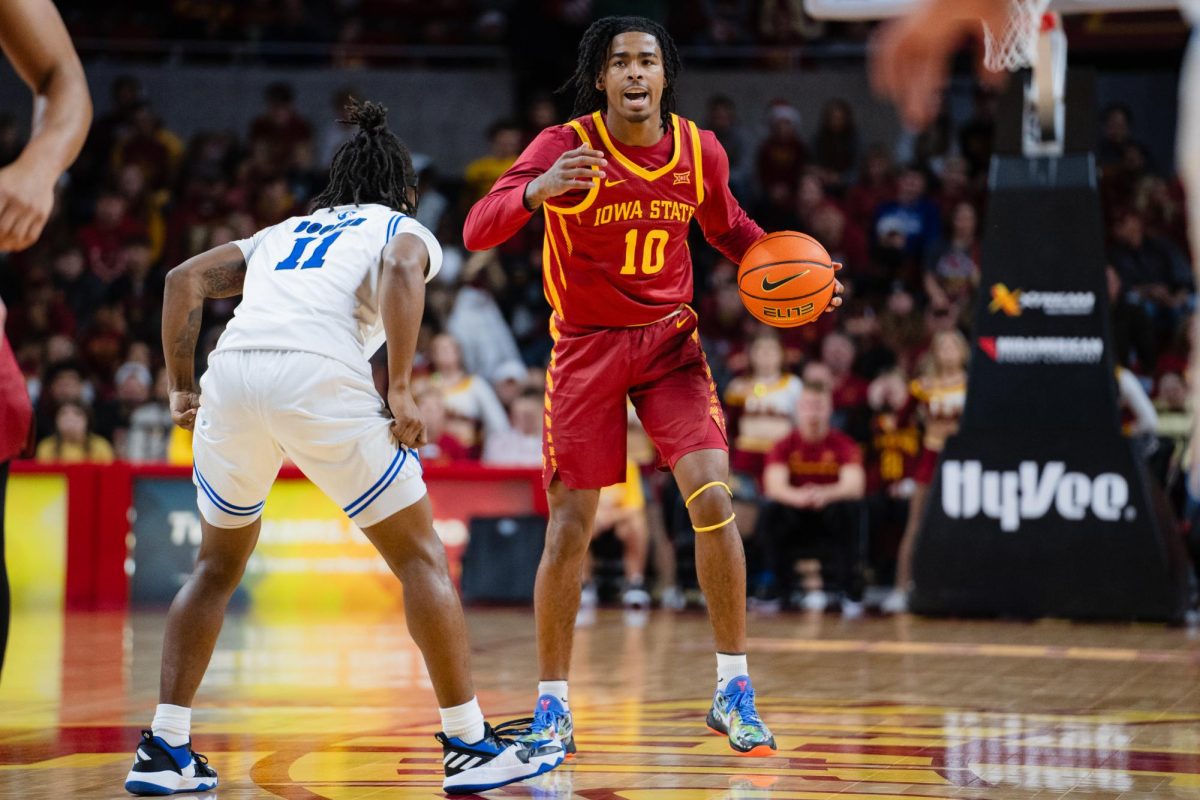 Junior guard Keshon Gilbert yells to his teammates while moving the ball up the court during the Iowa State vs. Eastern Illinois University men's basketball game, Hilton Coliseum, Dec. 21, 2023.