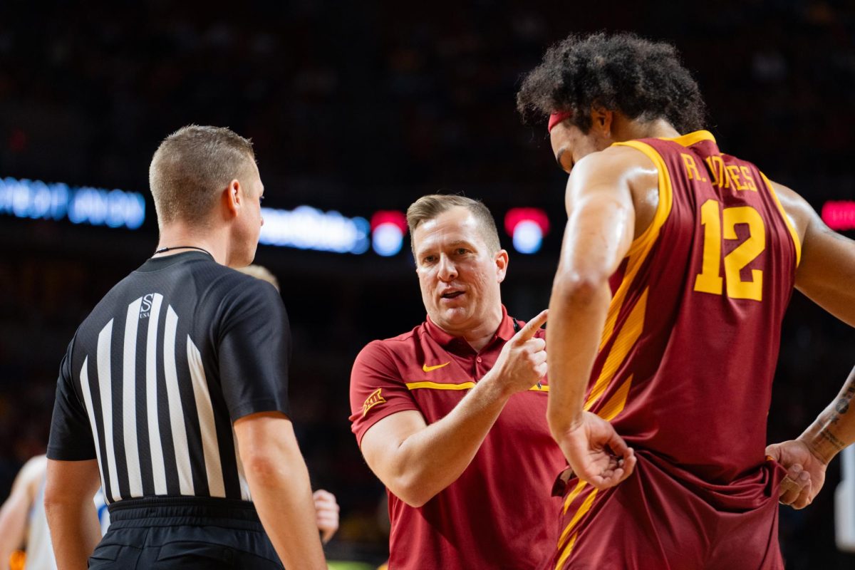 Head Coach speaks with Robert Jones and a referee during a media timeout at the Iowa State vs. Eastern Illinois University mens basketball game, Hilton Coliseum, Dec. 21, 2023.