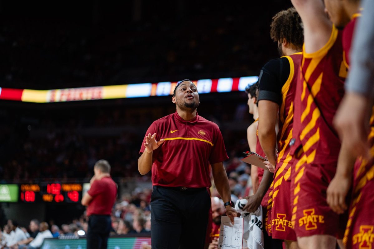 Assistant Director of Player Development Stevie Taylor reacts to a shot by Curtis Jones during the second half od the Iowa State vs. Eastern Illinois University men's basketball game, Hilton Coliseum, Dec. 21, 2023.