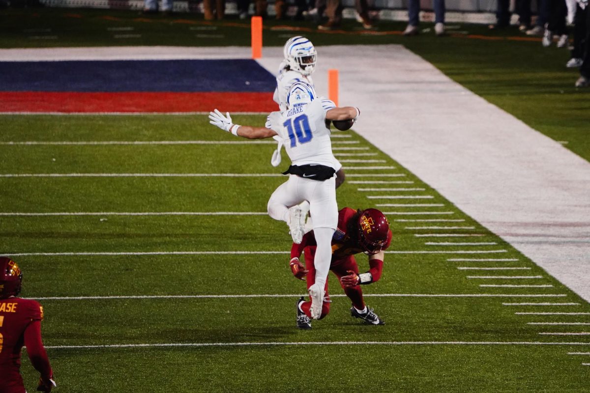 Memphis wide receiver Koby Drake leaps over an Iowa State defender during the 2023 AutoZone Liberty Bowl, Simmons Bank Liberty Stadium, Dec. 29. 2023.