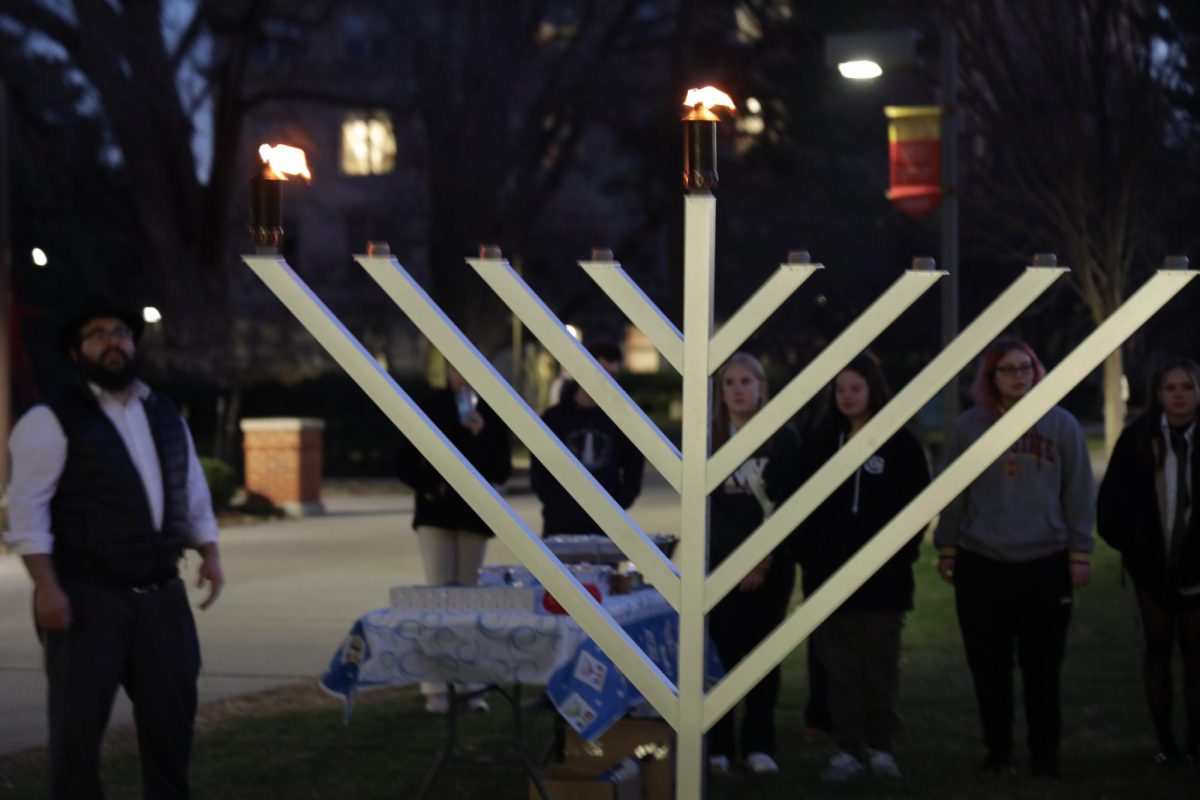 Those who know the song, sing Maoz Tzur after the lighting of the menorah outside Parks Library on Thursday, Dec. 7, 2023. Tonight is the first night of Hanukkah. 