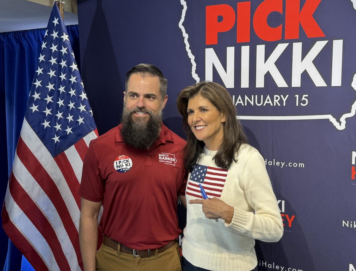 Former U.N. Ambassador and South Carolina Gov. Nikki Haley takes a photo with Nevada Mayor and Story County GOP Chair Brett Barker, who endorsed her during a campaign stop at the Story County fairgrounds community center on Dec. 18, 2023.