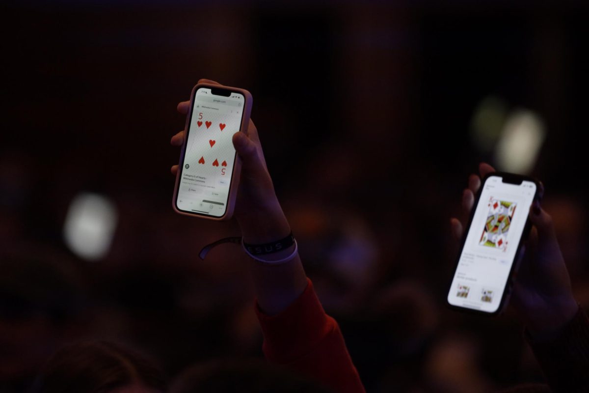 Audience members hold up their phones to assist magician Trigg Watson with a trick at his show in the Memorial Union Great Hall during Winterfest on Friday, Dec. 1, 2023. Watson was a semifinalist on Americas Got Talent this year. 