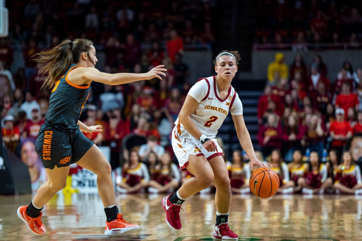 Arianna Jackson dribbling into the defender during the Iowa State vs. Oklahoma State game in Hilton Coliseum, Jan. 31, 2024.