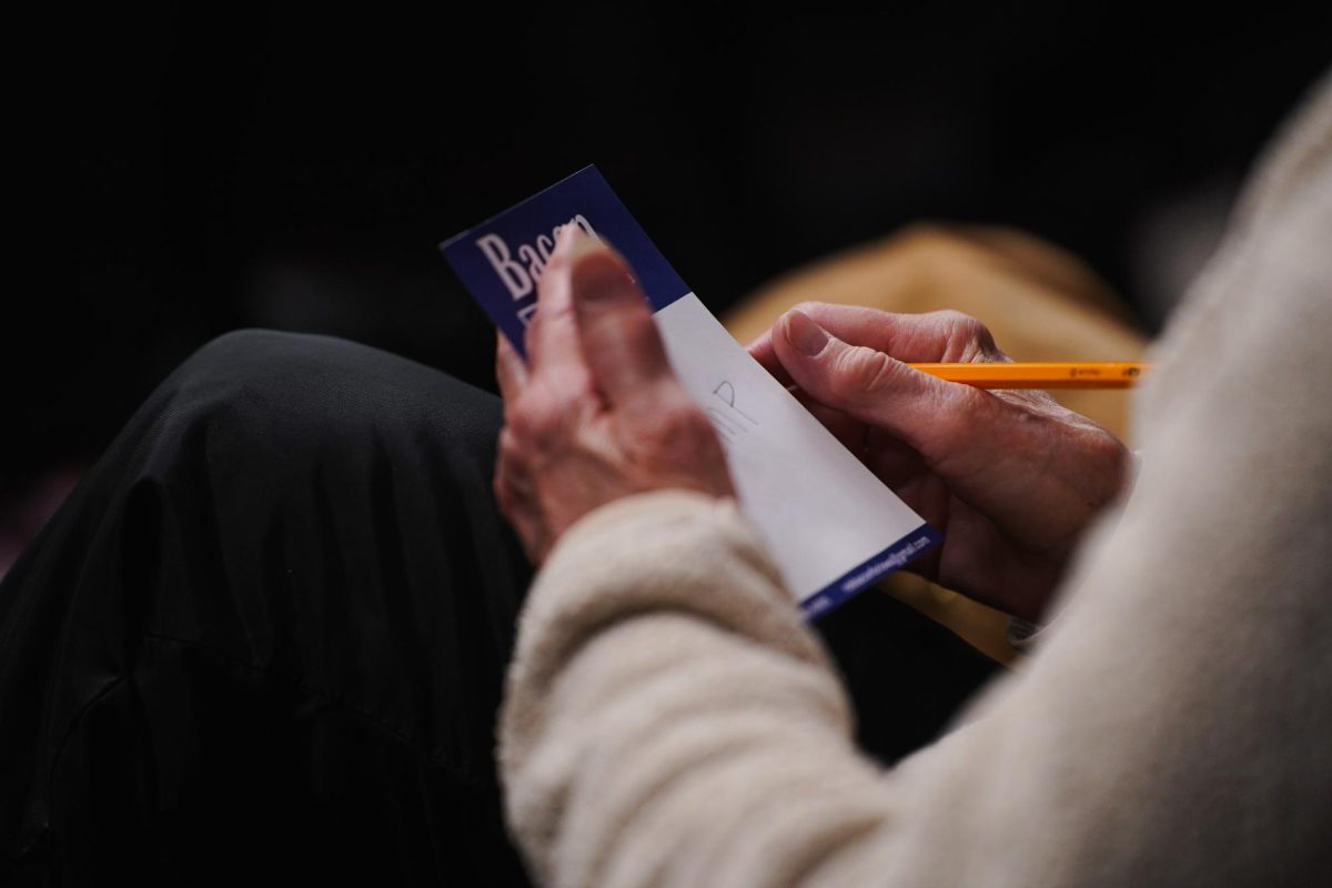 An attendee of the Ames precinct 1 caucus writes their ballot vote for the 2024 Iowa Republican Caucus, Memorial Union, Jan. 15, 2024.