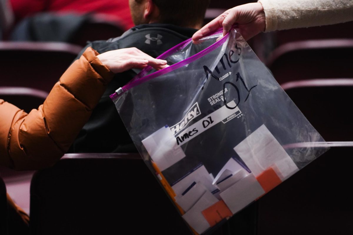 A clear bag is brought around the Campanile room during the ballot collection of the 2024 Iowa Republican Caucus, Memorial Union, Jan. 15, 2024.