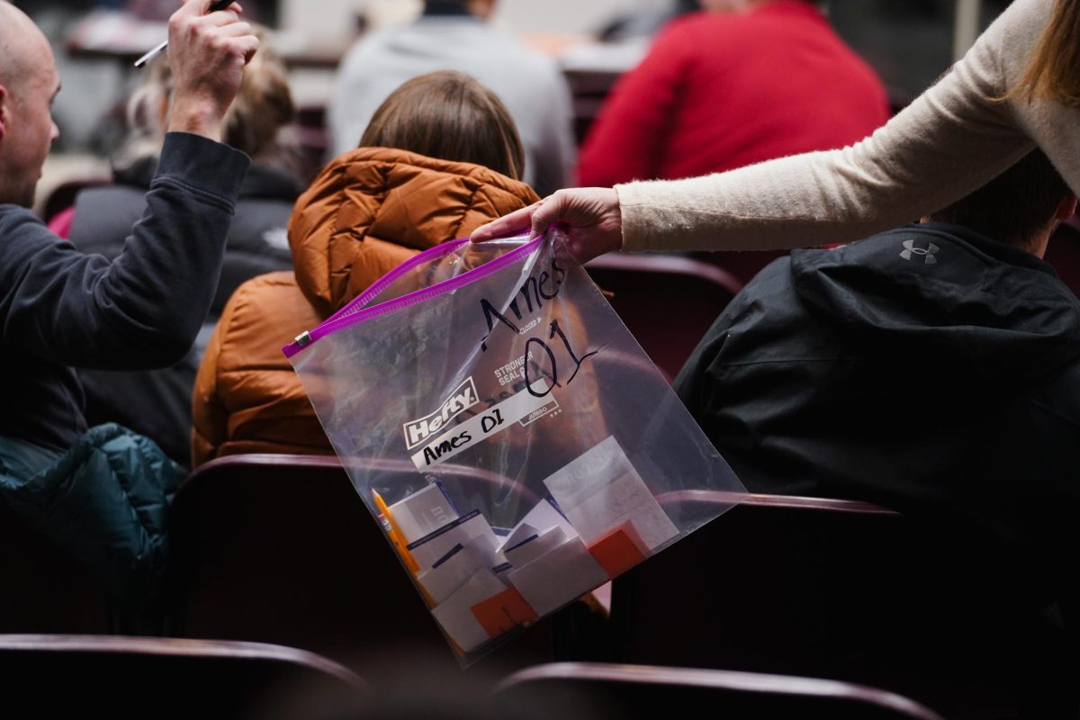 A clear bag is brought around the Campanile room during the ballot collection of the 2024 Iowa Republican Caucus, Memorial Union, Jan. 15, 2024.