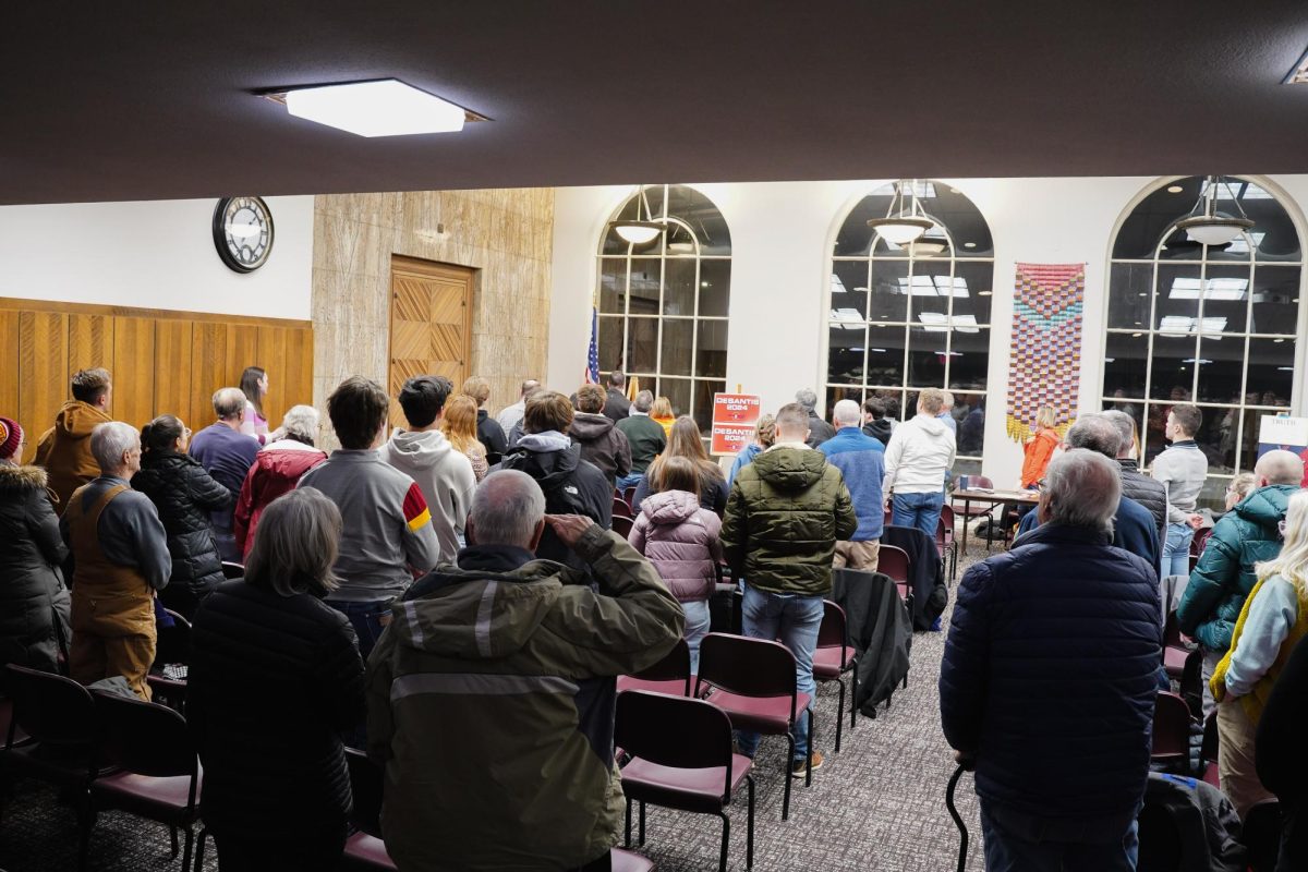 Attendees of the 2024 Iowa Republican Caucus take part in the Pledge of Allegiance, Memorial Union, Jan. 15, 2024.