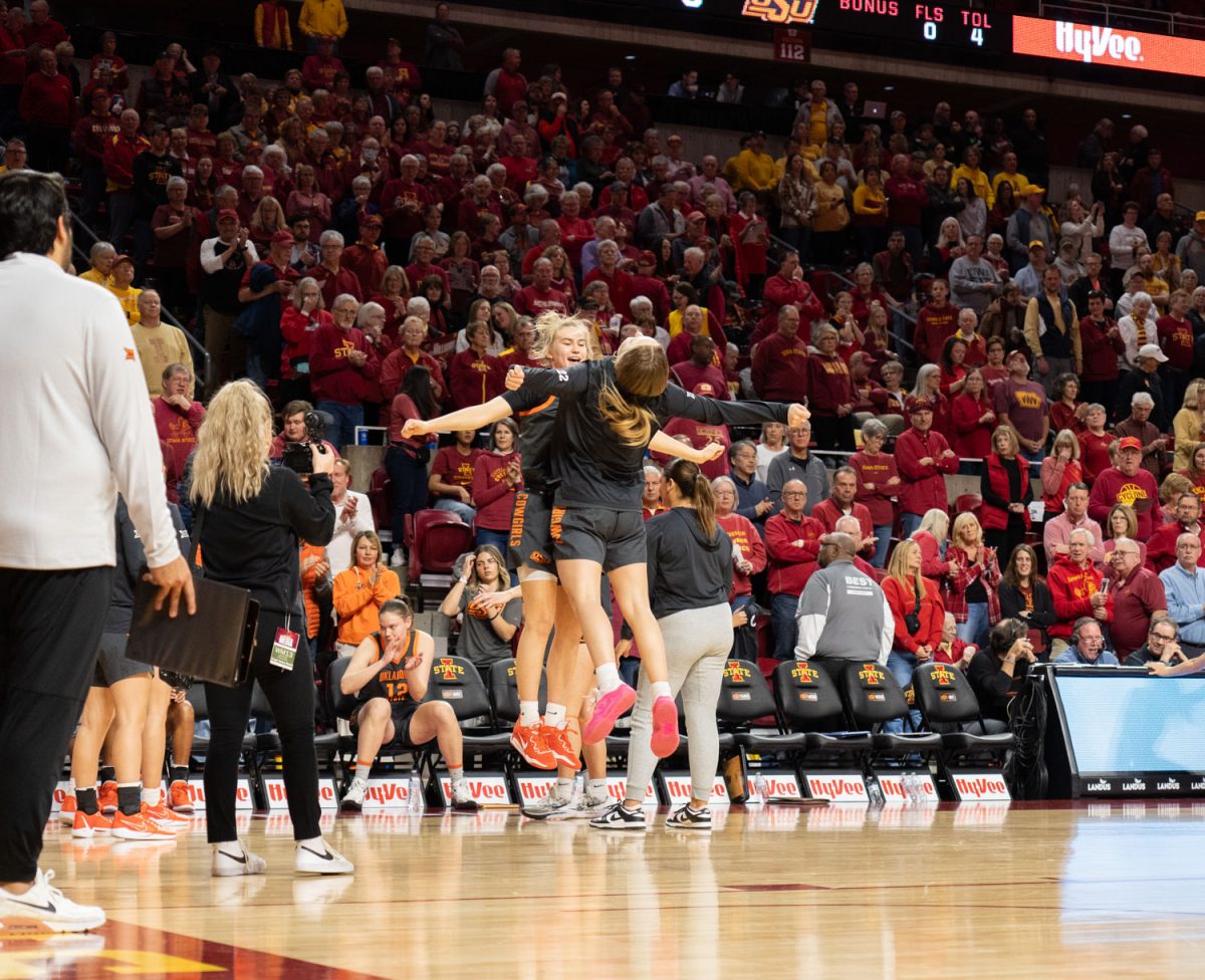 Starting Junior, Anna Gret Asi, chest bumps Mia Galbraith as she gets announced for Oklahoma State Universities starting lineup at the Iowa State vs. Oklahoma State womens basketball game at Hilton Coliseum, Jan. 31, 2024.  