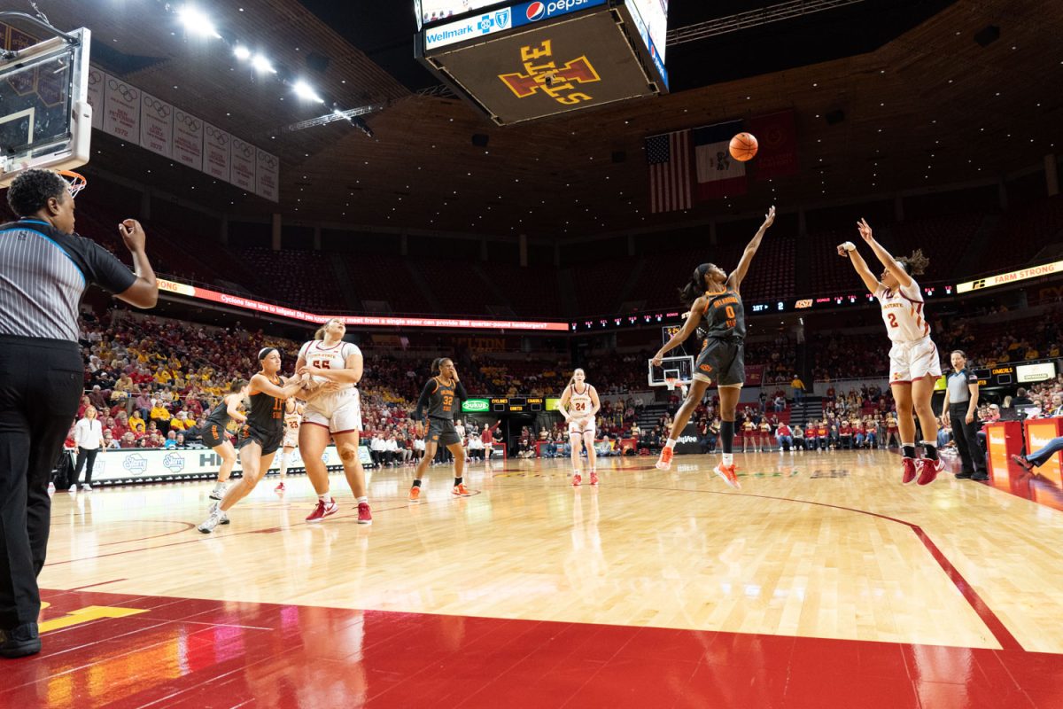 Arianna Jackson shoots a three over Quincy Noble at the Iowa State vs. Oklahoma State womens basketball game at Hilton Coliseum, Jan. 31, 2024.  