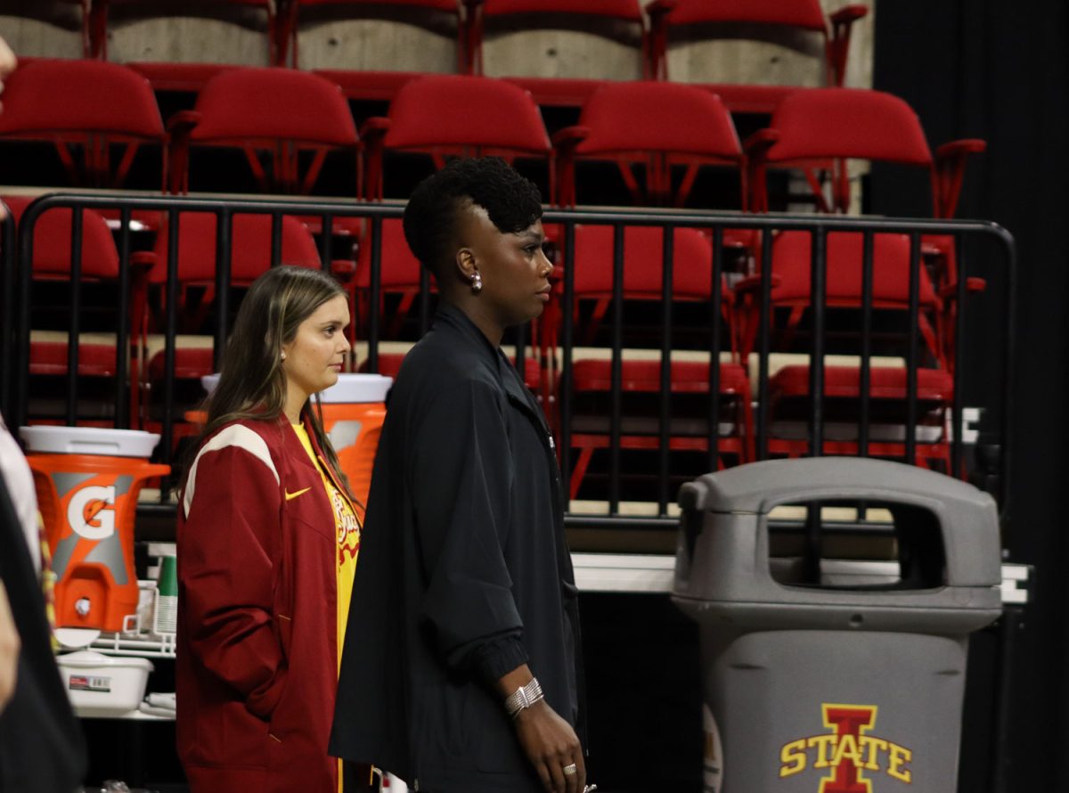 Head Coach Ashley Miles Greig stands and watches her gymnasts perform at the Cyclones vs Illinois State University gymnastics meet at Hilton Coliseum, Jan. 26, 2024.    