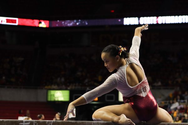 Junior Hannah Loyim strikes a pose on the balance beam at the Cyclones vs Illinois State University gymnastics meet at Hilton Coliseum, Jan. 26, 2024.  