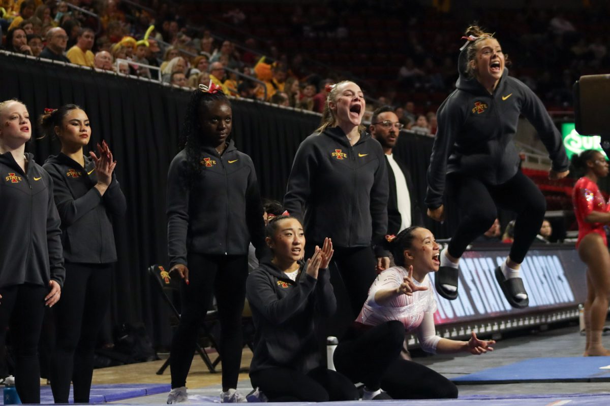 Cyclone gymnasts cheer big while a teammate performs on the balance beam at the Cyclones vs Illinois State University gymnastics meet at Hilton Coliseum, Jan. 26, 2024.   