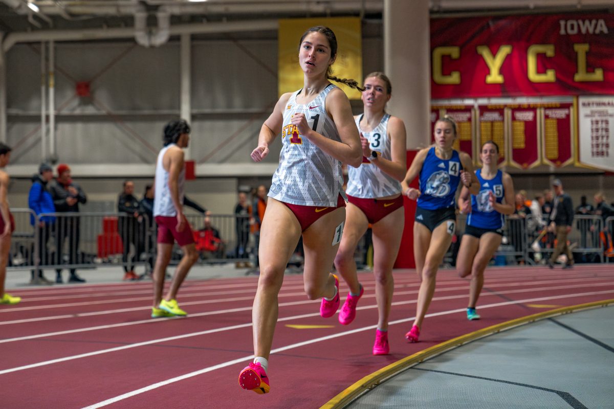 Mya Trober runs with teammate Kaylee Tobaben for the womens 1 mile race during the 2024 Cyclone Open on Jan. 19, 2024.
