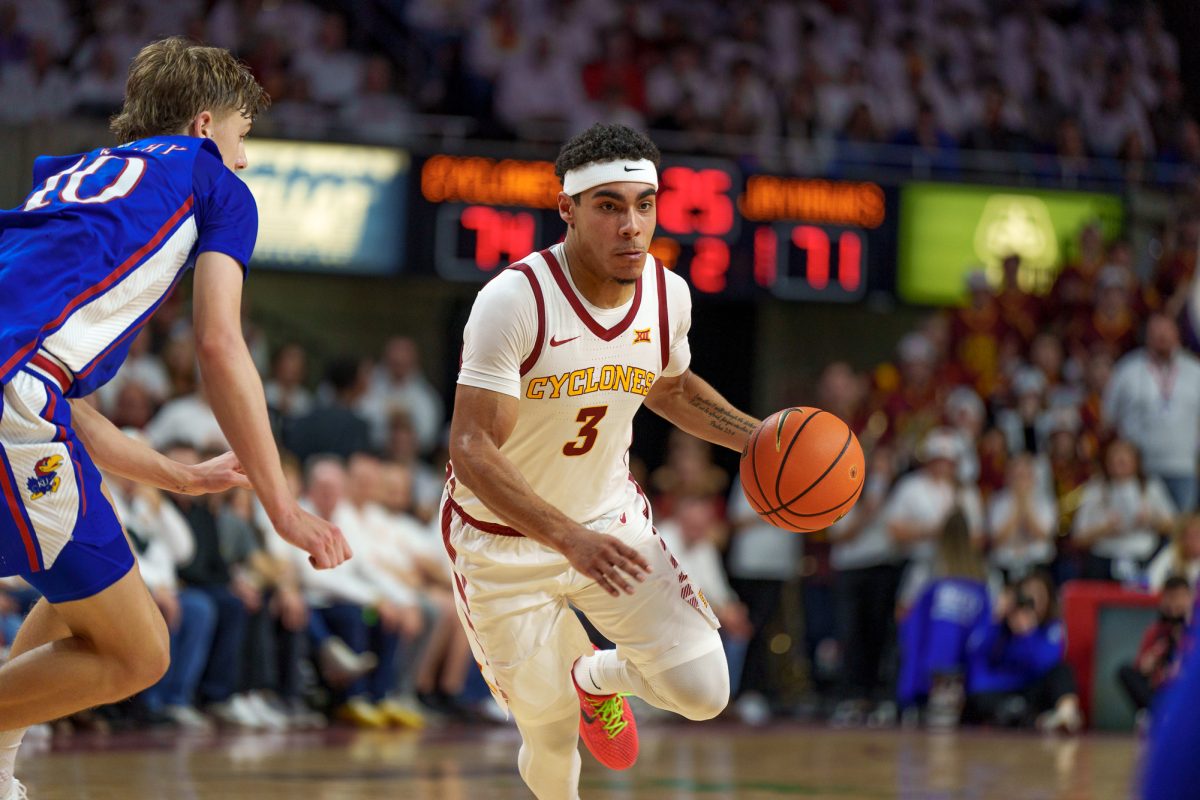 Point+guard+Tamin+Lipsey+pushes+past+Johnny+Furphy+of+Kansas+to+make+two+during+the+Iowa+State+vs.+Kansas+match+on+Jan.+27%2C+2024+in+Hilton+Coliseum.