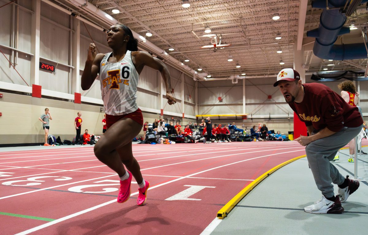 Director of Track & Field/Cross Country Jeremy Sudbury encourages Rachel Joseph to keep pushing during the womens 200m dash at the Cyclone Open event on Jan. 19, 2024.