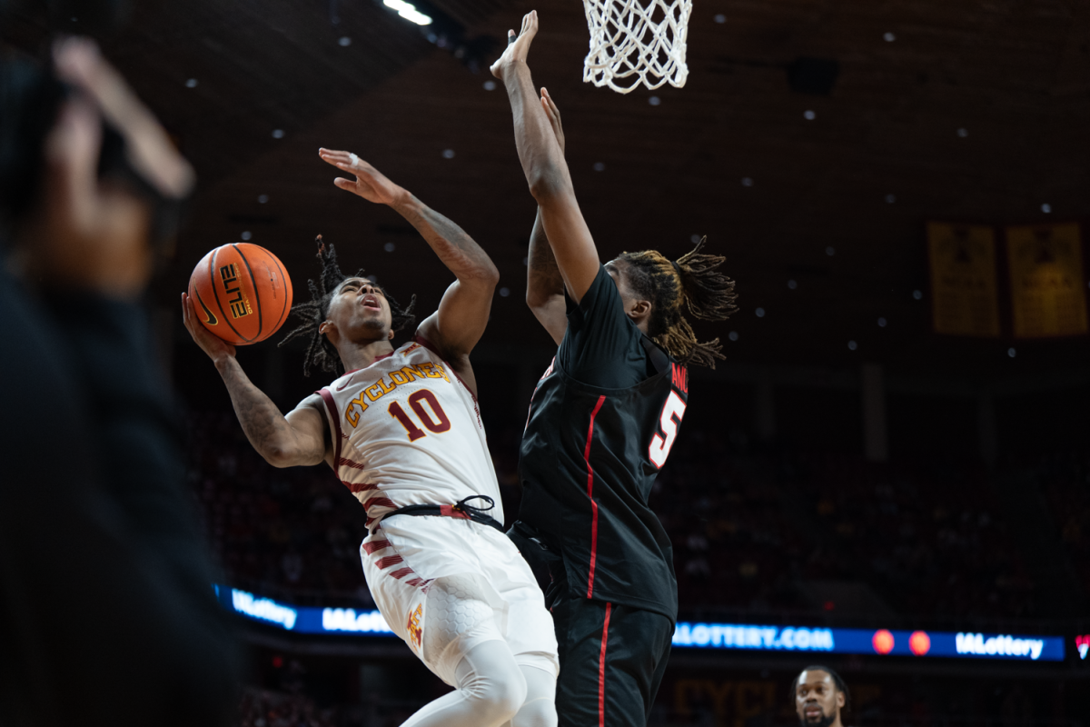 Keshon Gilbert embraces the contact while driving to the hoop against Houston at Hilton Coliseum on Jan. 9, 2023.