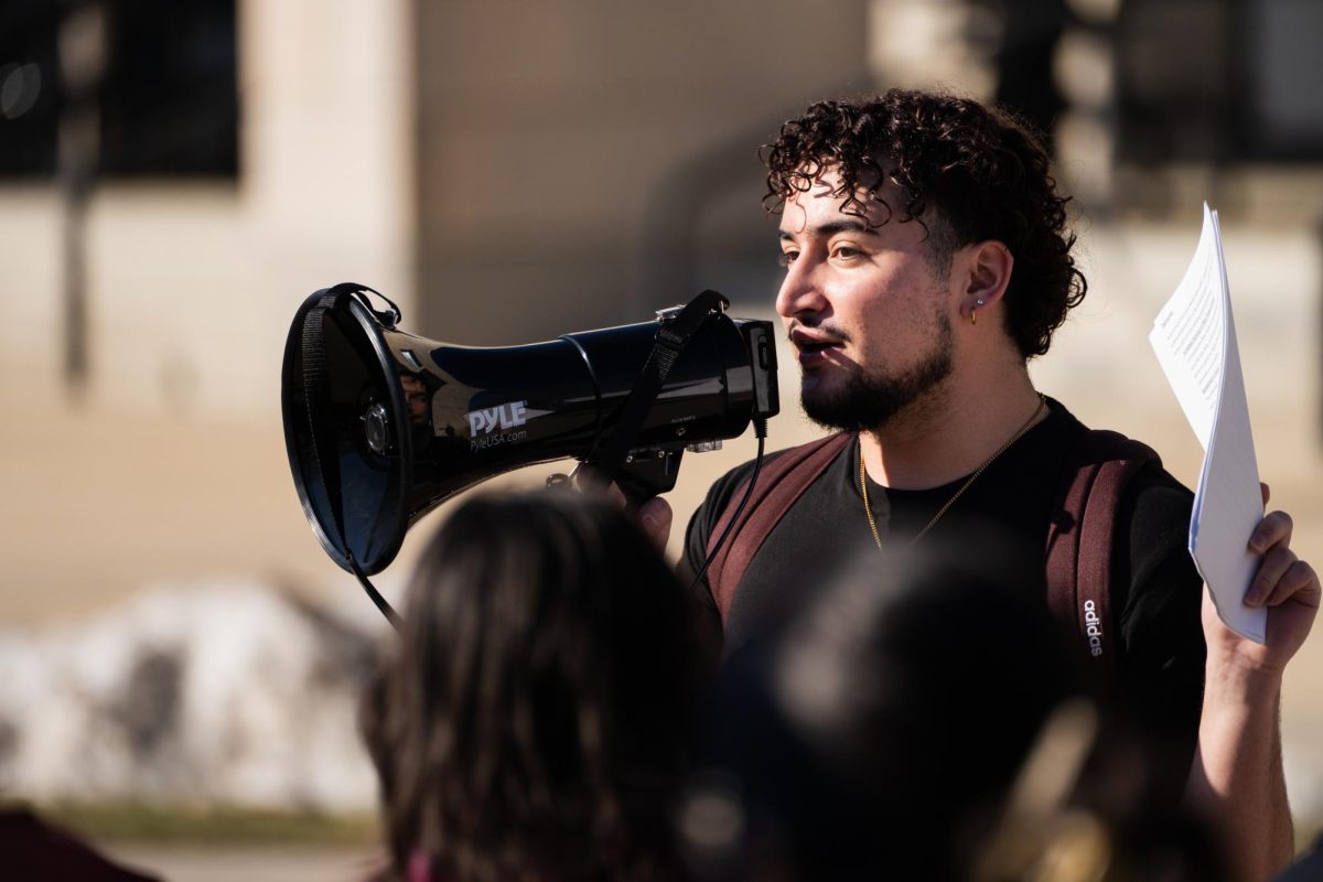Endi Montalvo-Martinez informs Iowa State students on the walking route before the Color of Love protest outside of the Parks Library on Feb. 1, 2024. 