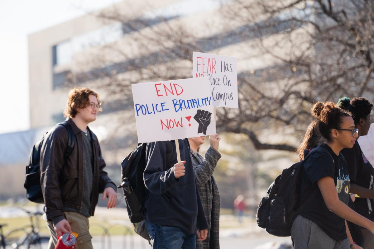 Un-named student holds sign up saying, End police brutality now! during the Officer Frankie Contreras protest organized by Color of Love on Feb. 1, 2024.