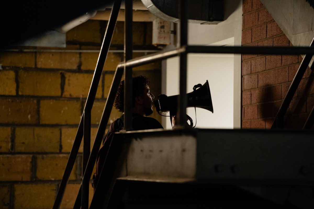 Color of Love organized protestor Endi Montalvo-Martinez uses a megaphone across the Armory while demanding for the immediate firing of Officer Frankie Contreras from the ISUPD. This is in response to the police brutality exhibited by Officer Contreras onto civilian Dariq Myles. Feb. 1, 2024. 