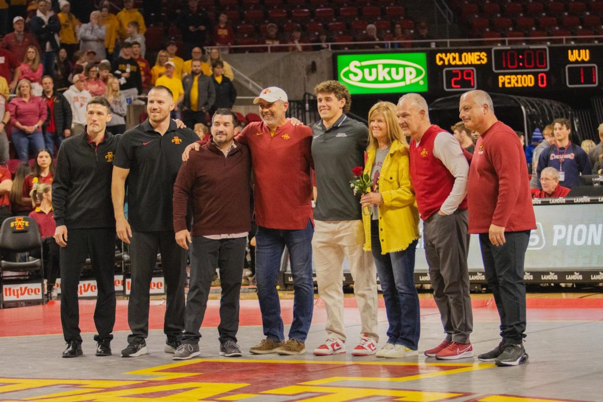 Carter Schmidt with his coached and family during senior night after the Iowa State vs West Virginia wrestling dual on Feb. 2, 2024 at Hilton Coliseum.