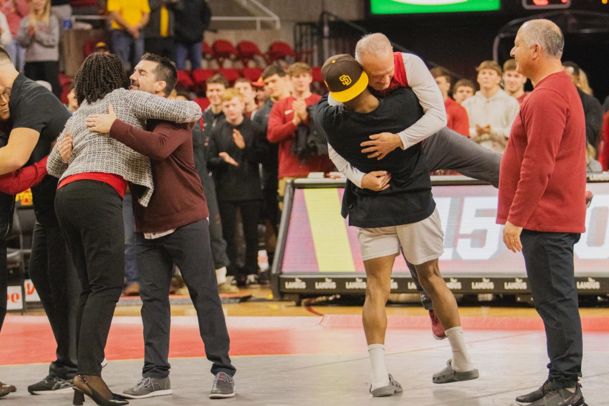 David Carr hugs his coach during senior night after the Iowa State vs West Virginia wrestling dual on Feb. 2, 2024 at Hilton Coliseum.